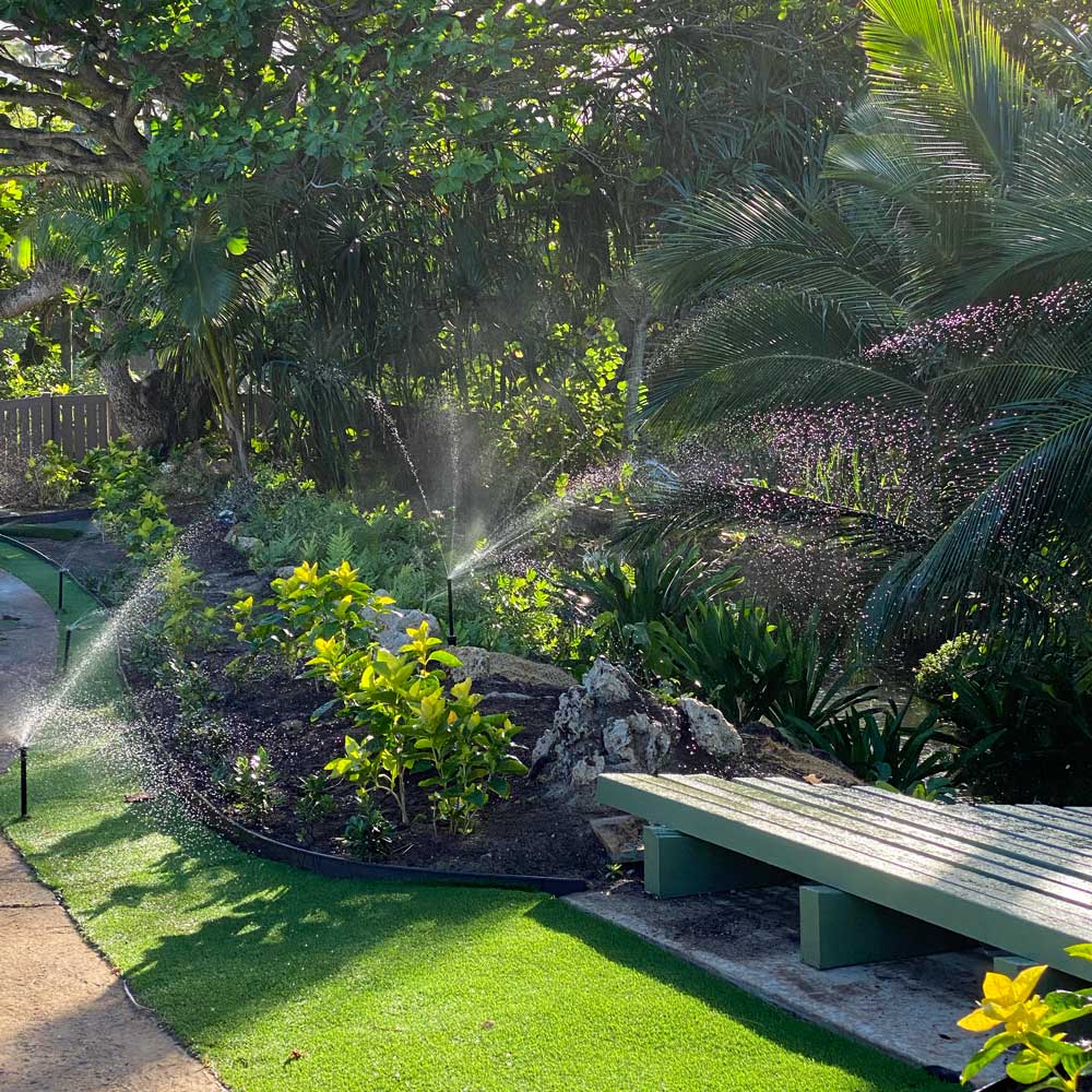 Landscape irrigation around a lush beautiful garden on the island of oahu 